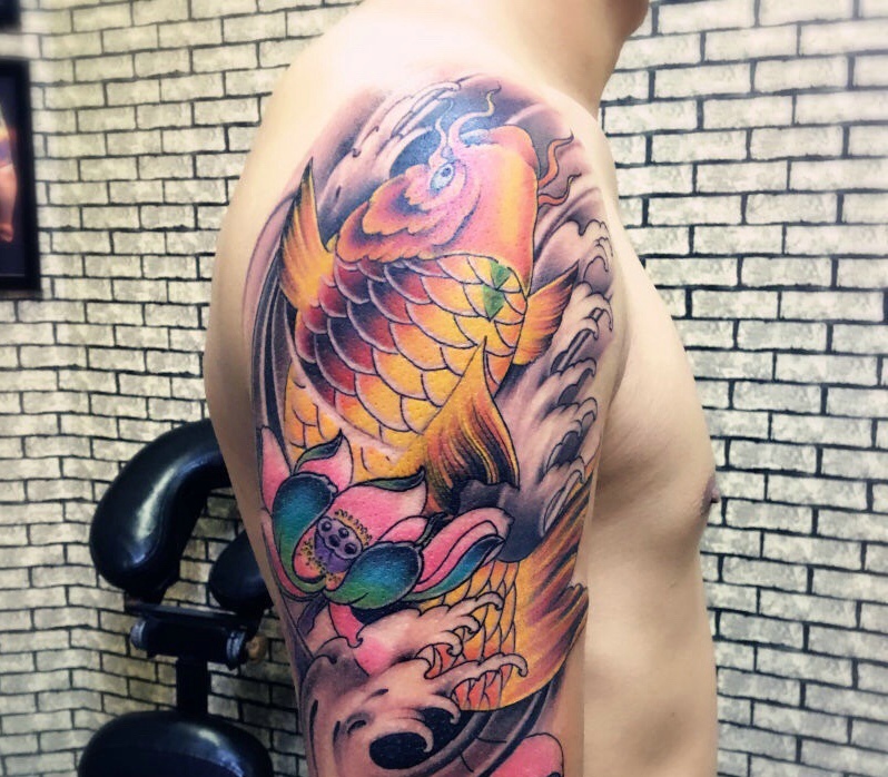 点击大图看下一张：大臂彩色鲤鱼与莲花的纹身图案
