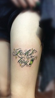 性感长腿上的荧光绿花体英文纹身