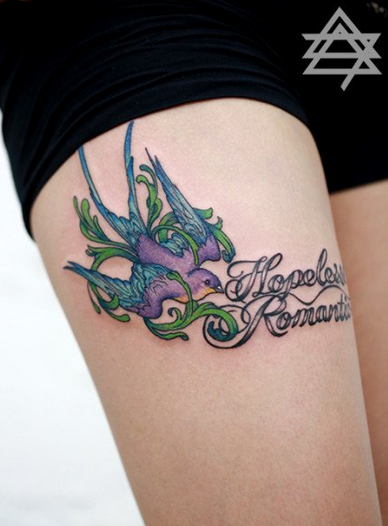 点击大图看下一张：女生大腿彩色小燕子与字母纹身图案