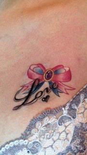 美女胸部标致的蝴蝶结与字母纹身图案