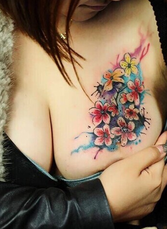 点击大图看下一张：女性胸部漂亮的花卉纹身图案