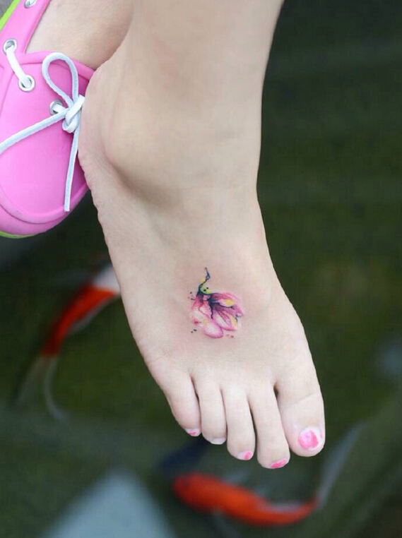 点击大图看下一张：女生脚背上好看的小花纹身