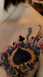 女性胸部花卉和黑桃纹身