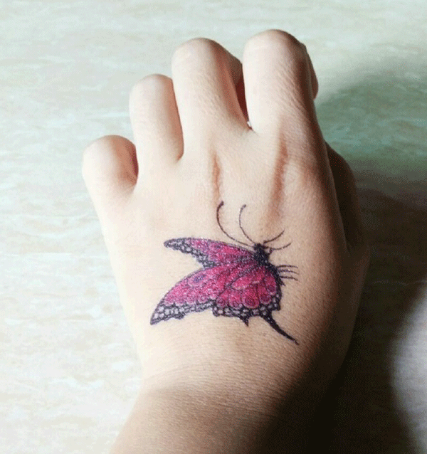 点击大图看下一张：女性手背玫瑰色蝴蝶纹身图案