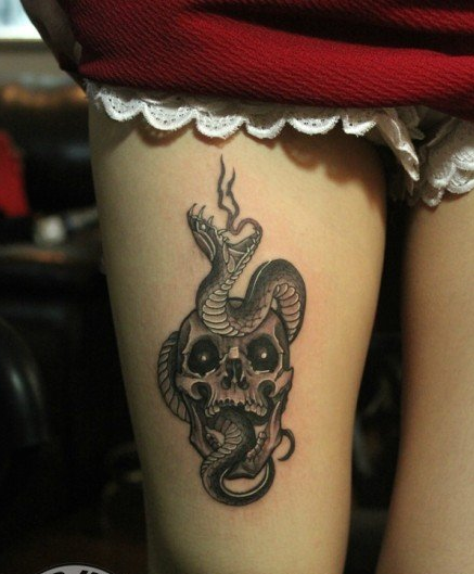 点击大图看下一张：女性大腿上的骷髅蛇纹身