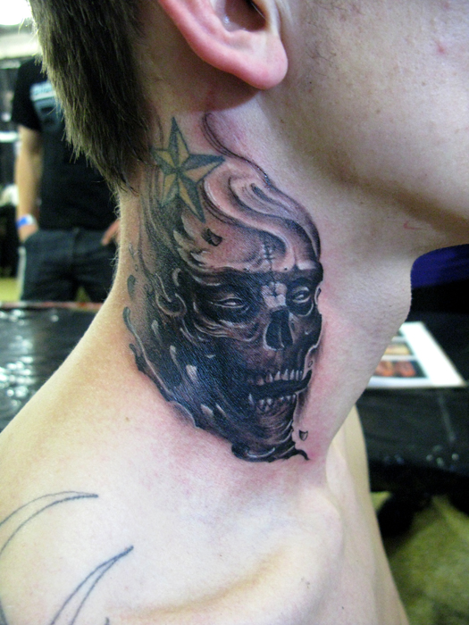 点击大图看下一张：男性脖子上骷髅头纹身图案
