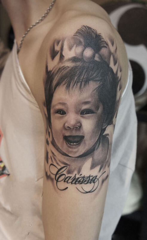 点击大图看下一张：男生手臂可爱宝宝肖像刺青作品