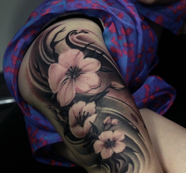 点击大图看下一张：女性大臂上有着三朵花朵纹身