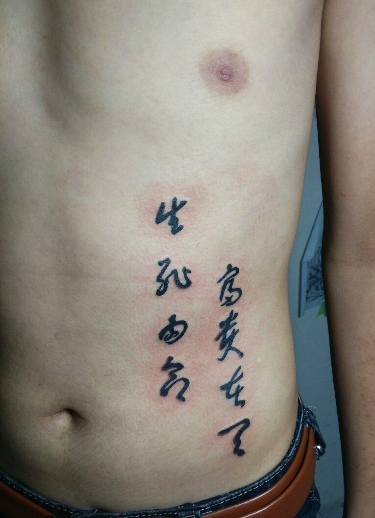 点击大图看下一张：落在男士腰部上的个性汉字纹身刺青