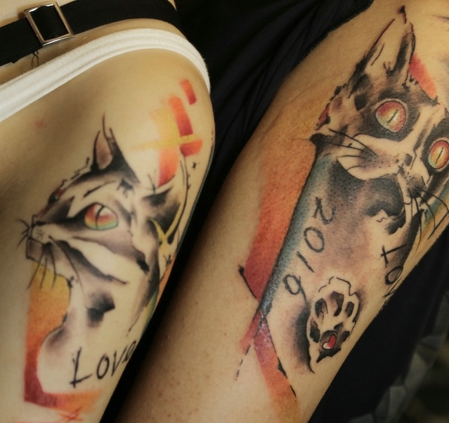 点击大图看下一张：一对情侣花猫手臂纹身刺青
