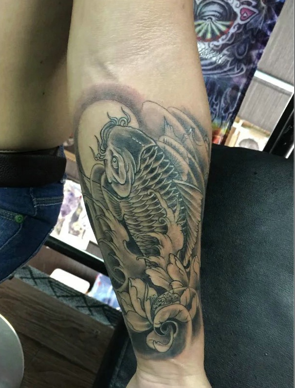 点击大图看下一张：手臂莲花鲤鱼纹身刺青显活力