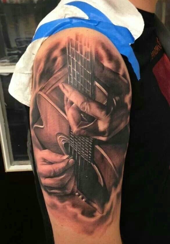 点击大图看下一张：两款个性独特的吉他纹身图案