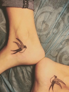 脚腕上的一对小燕子纹身图案