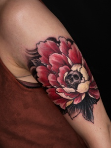 手臂被花包围着的骷髅纹身图案