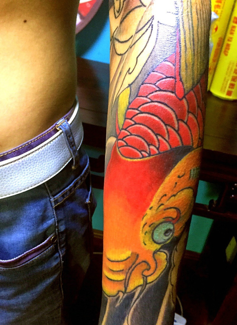 点击大图看下一张：花臂鲜艳无比的大红鲤鱼纹身图案
