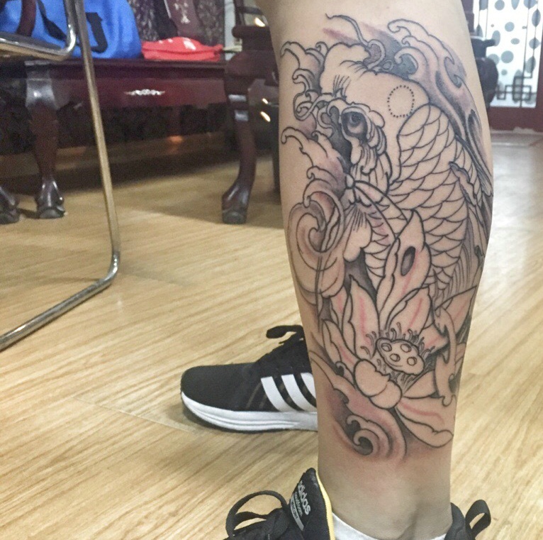点击大图看下一张：莲花与鲤鱼结合的腿部纹身图案