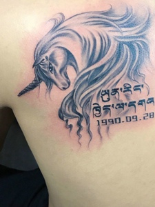 独角兽与梵文结合的背部纹身图案