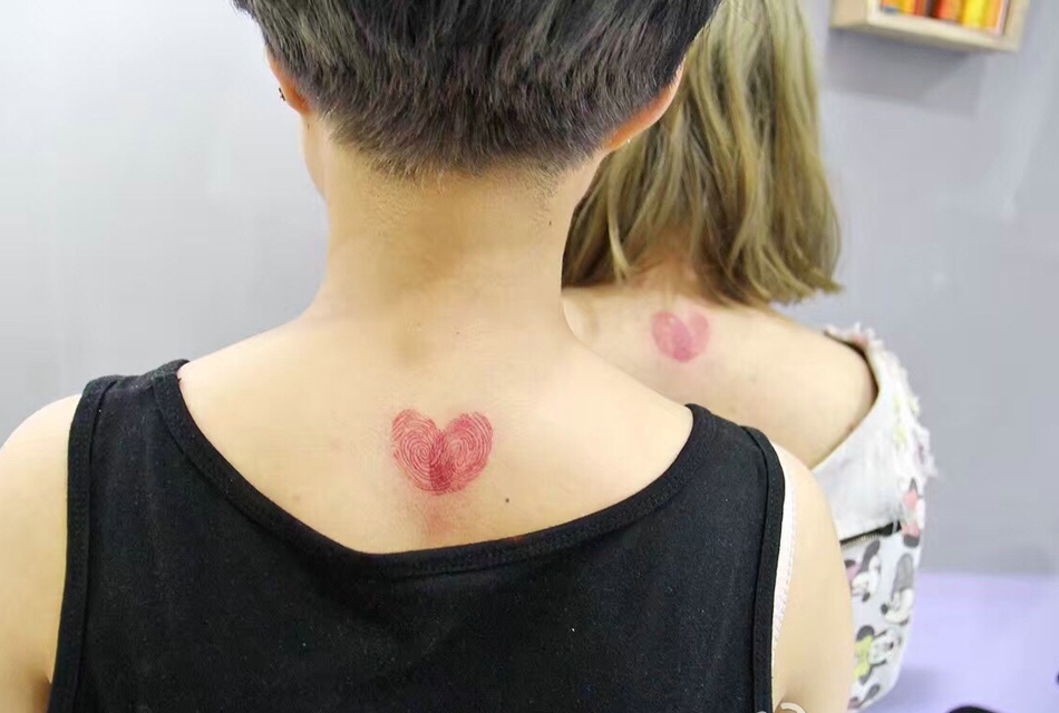 点击大图看下一张：颈部上的粉红爱心情侣闺蜜纹身图案