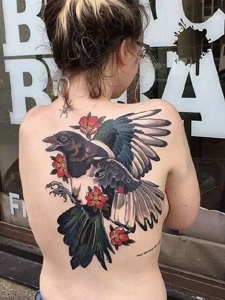 女生晳白的后背一只彩色乌鸦纹身图案